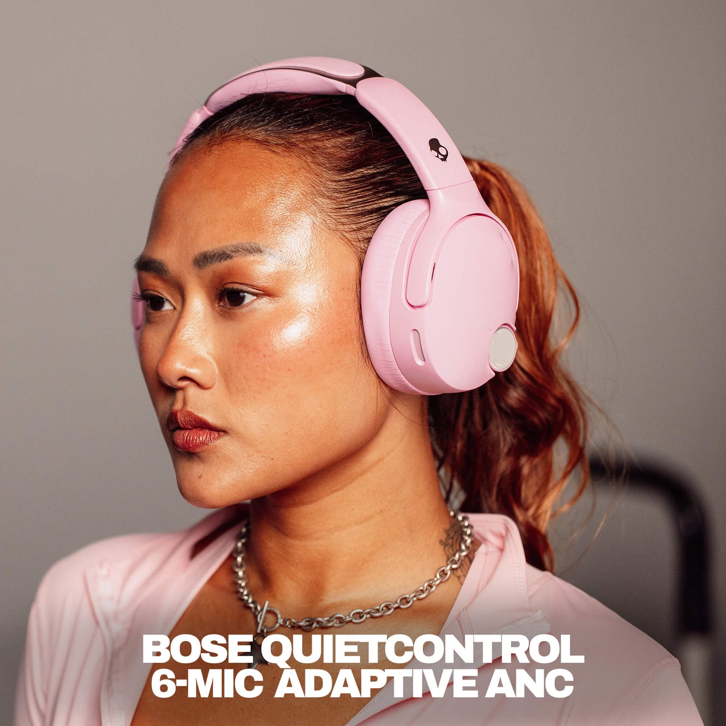 Woman wearing pink Skullcandy Crusher 1080 ANC with Bose QuietControl headphones with text overlay. | Candy