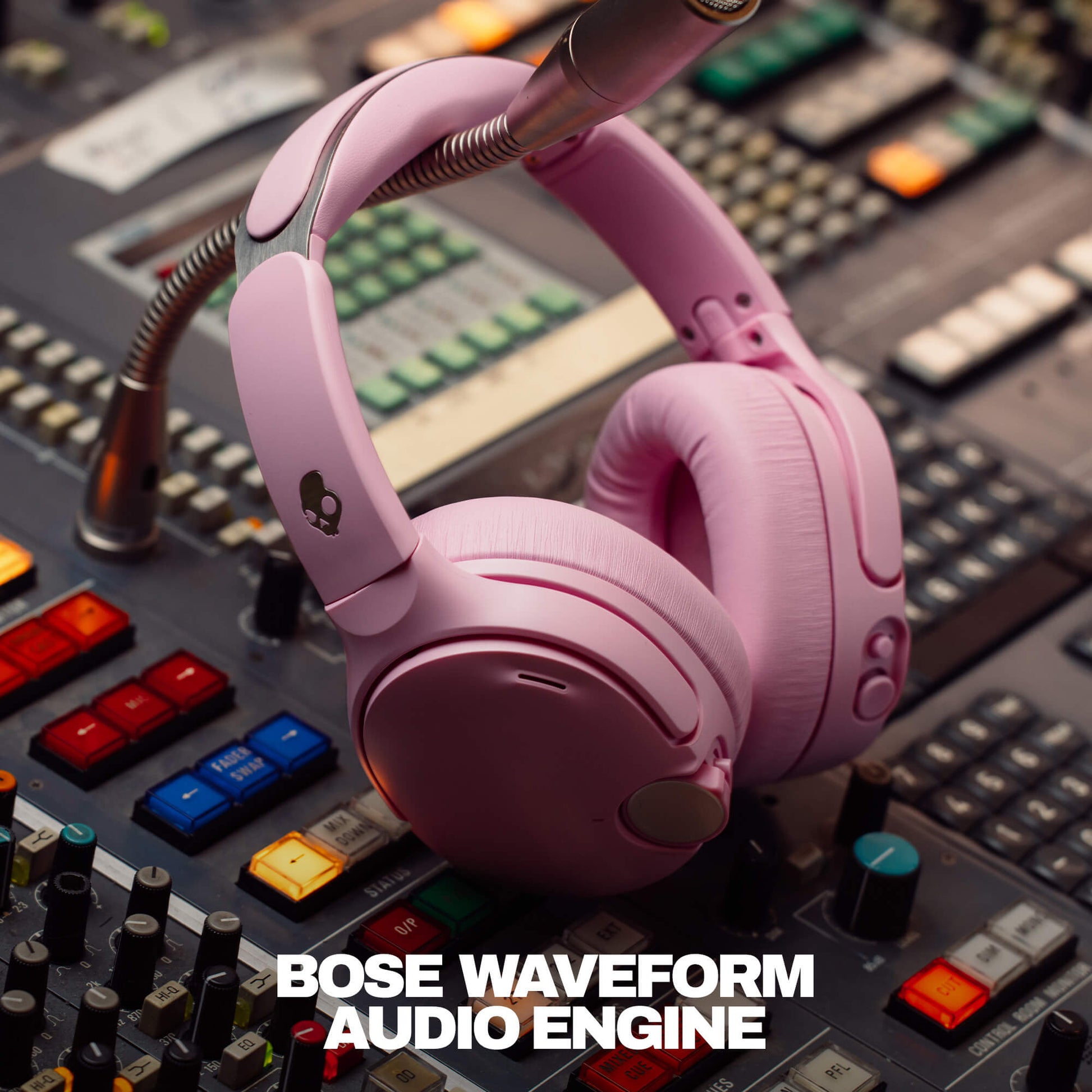 Skullcandy Crusher 1080 ANC Pink headphones on a mixing console with 'Bose Waveform Audio Engine' text. | Candy