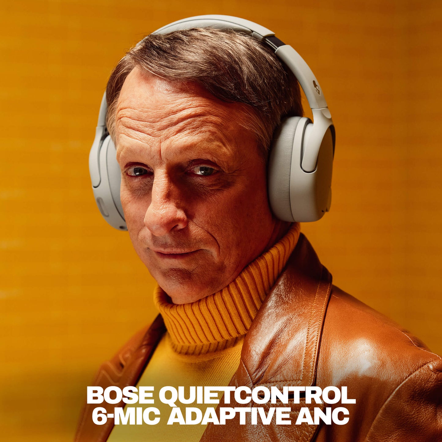 Tony Hawk wearing Skullcandy Crusher 1080 ANC headphones in grey | Cement