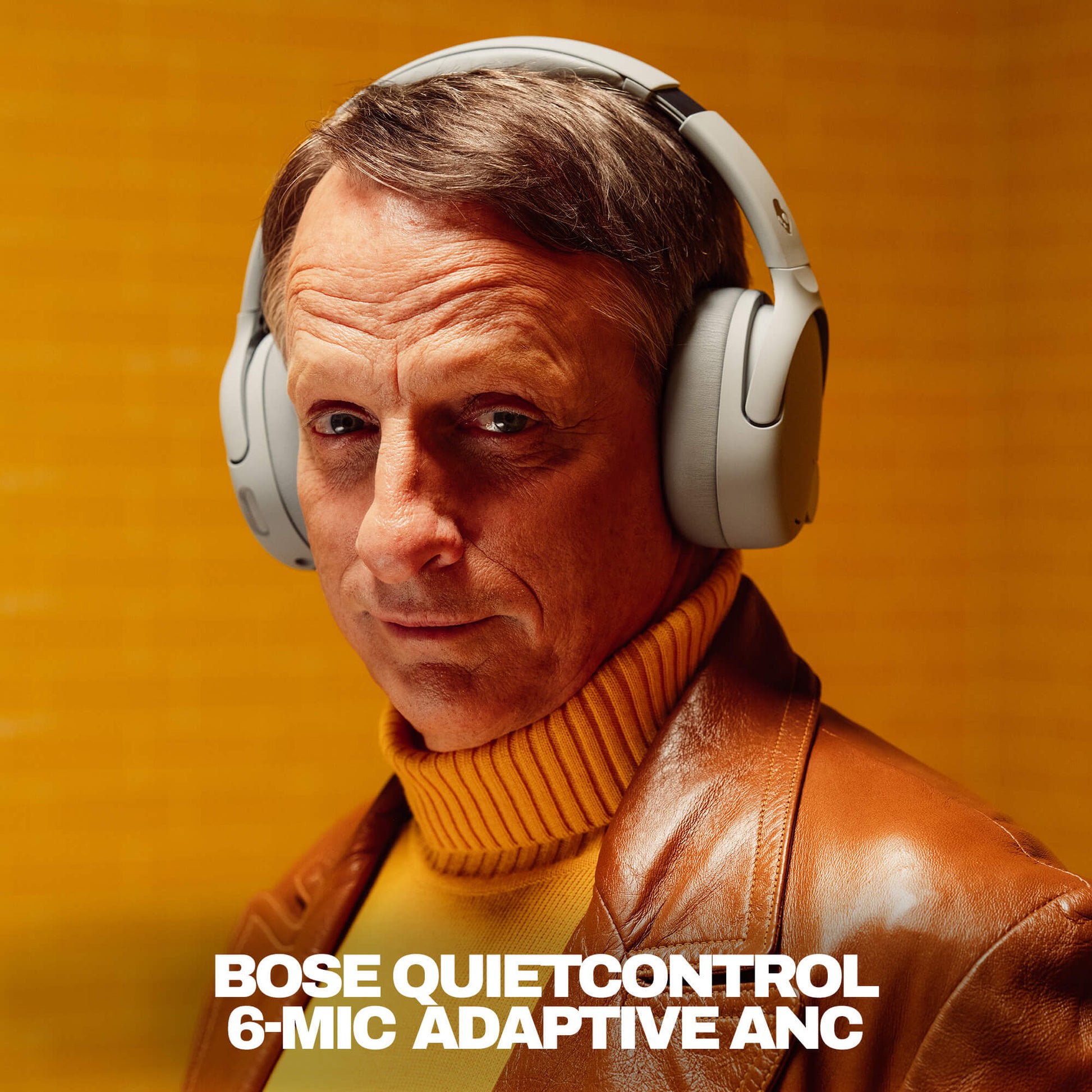 Tony Hawk wearing Skullcandy Crusher 1080 ANC headphones in grey | Cement