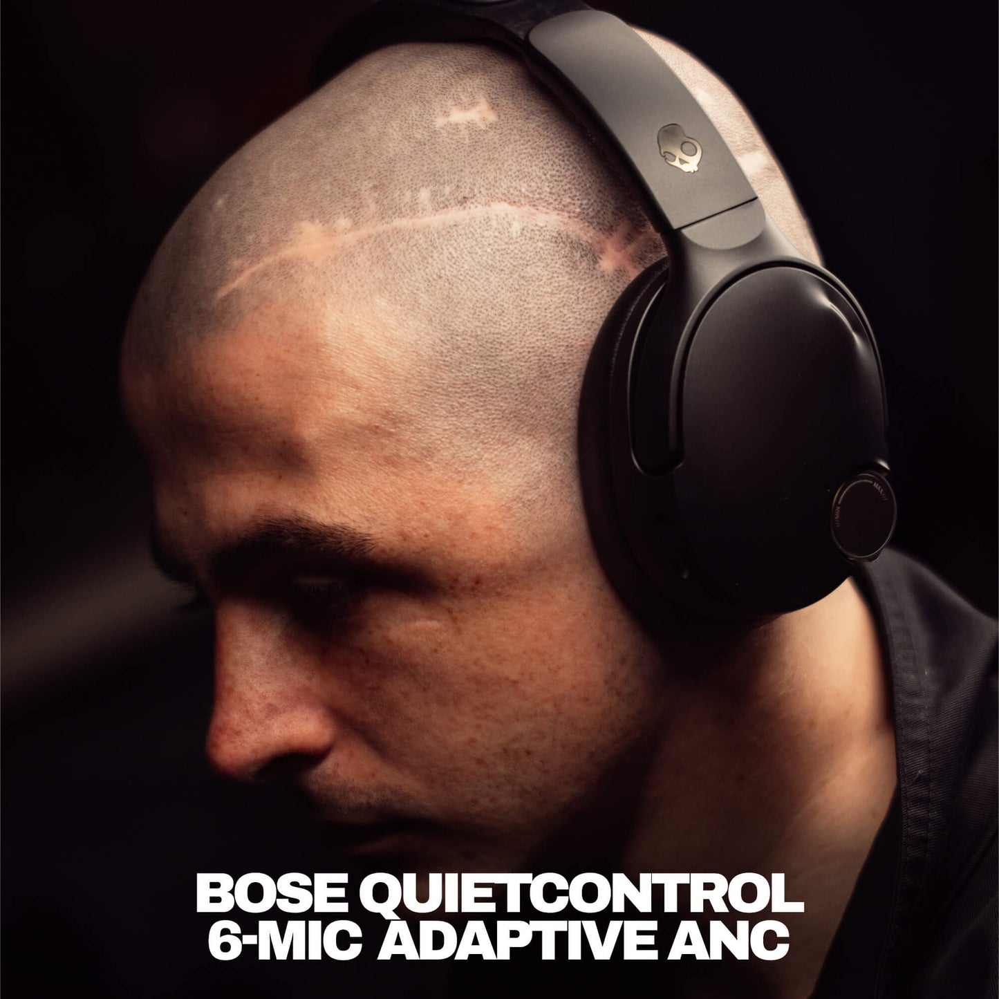 Man wearing Skullcandy Headphones with Bose QuietControl headphones with text indicating model details. | True Black