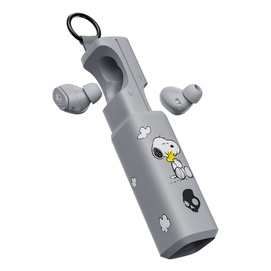 Gray wireless dime 360 earbuds with a matching charging case decorated with Snoopy and Woodstock illustrations, shown on a clean white background. | Skullcandy X Peanuts Woodstock & Snoopy