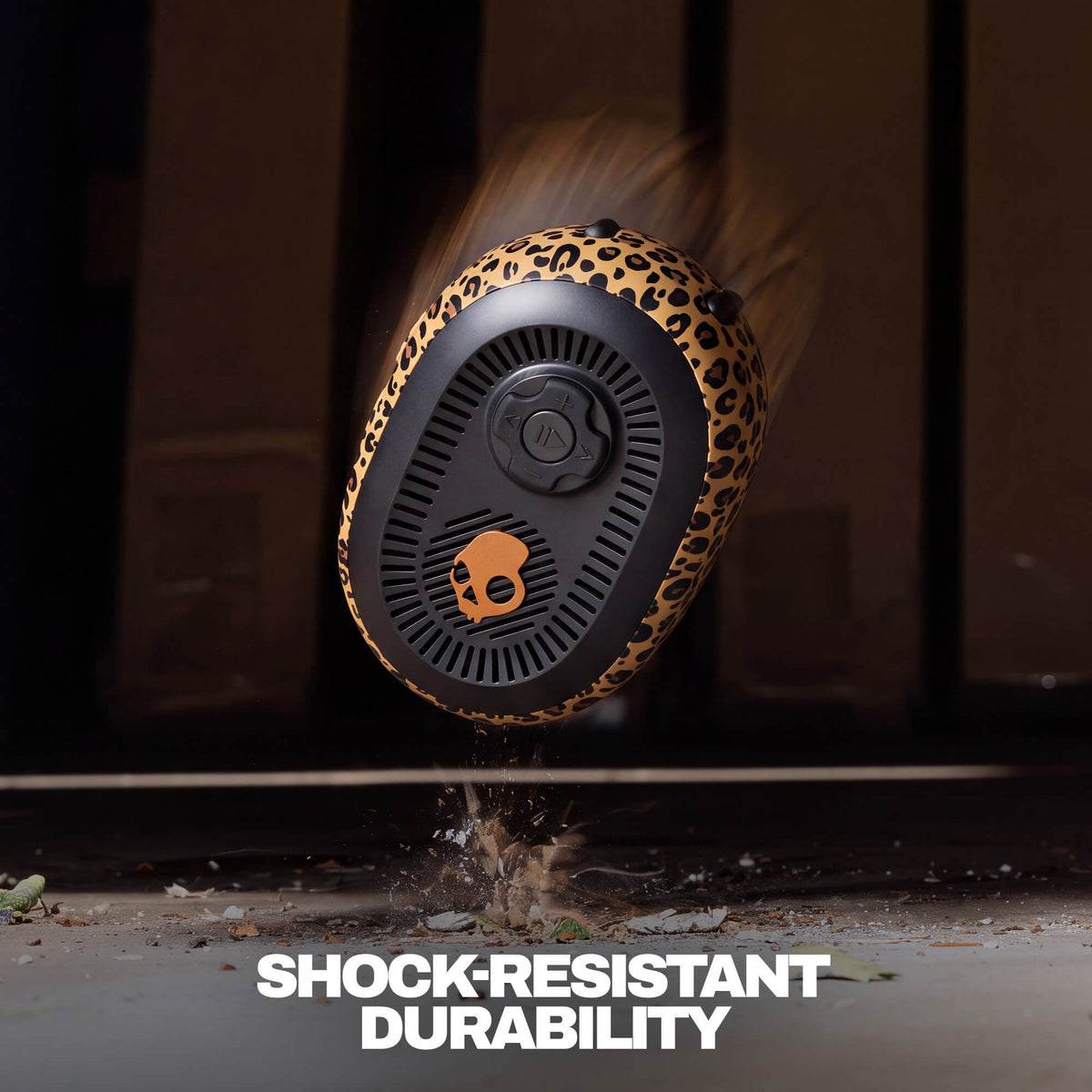 A rugged session 540 with leopard-print outer shell floating midair above a concrete surface. The image includes motion blur and debris at the base to emphasize shock resistance, with the text 'SHOCK-RESISTANT DURABILITY' at the bottom. | Leopard