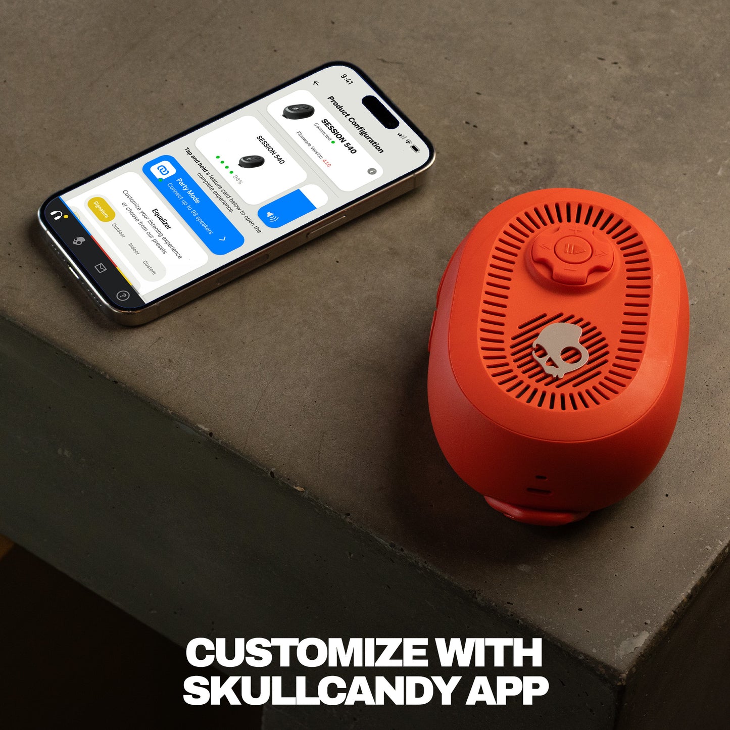red Bluetooth speaker next to a smartphone on a concrete surface with text 'Customize with Skullcandy App'. | Plasma