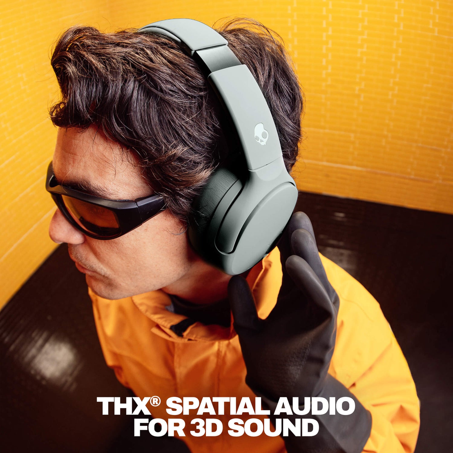 Person wearing Crusher 720 headphones with 'THX Spatial Audio For 3D Sound' text on a yellow background | Cement
