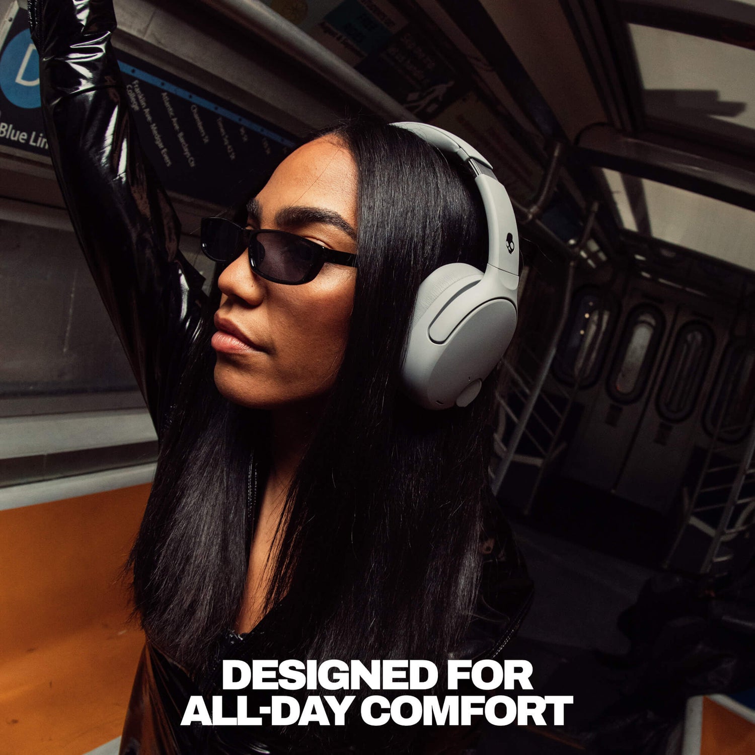 Person wearing Crusher 720 headphones and sunglasses inside a vehicle with text 'DESIGNED FOR ALL-DAY COMFORT'. | Cement